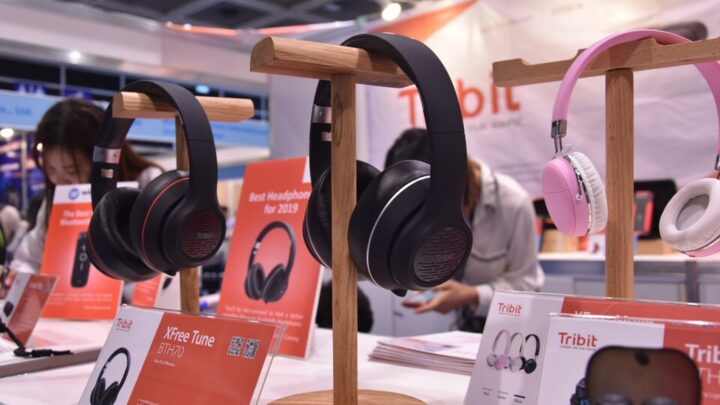 Over-ear Bluetooth headphones displayed at an electronics event