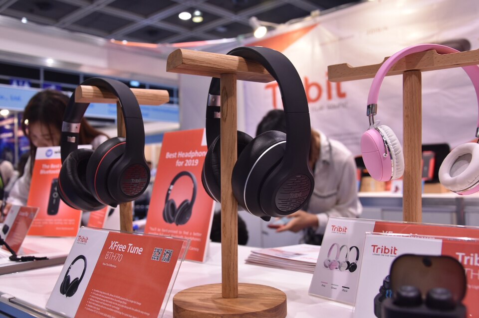 Over-ear Bluetooth headphones displayed at an electronics event