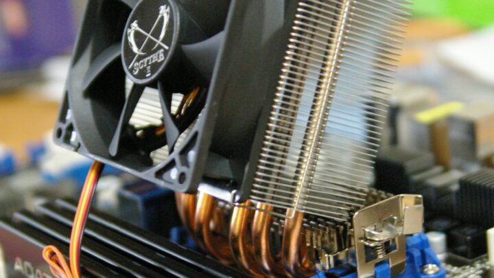 Desktop CPU heatsink with fan and heat pipes installed on a motherboard