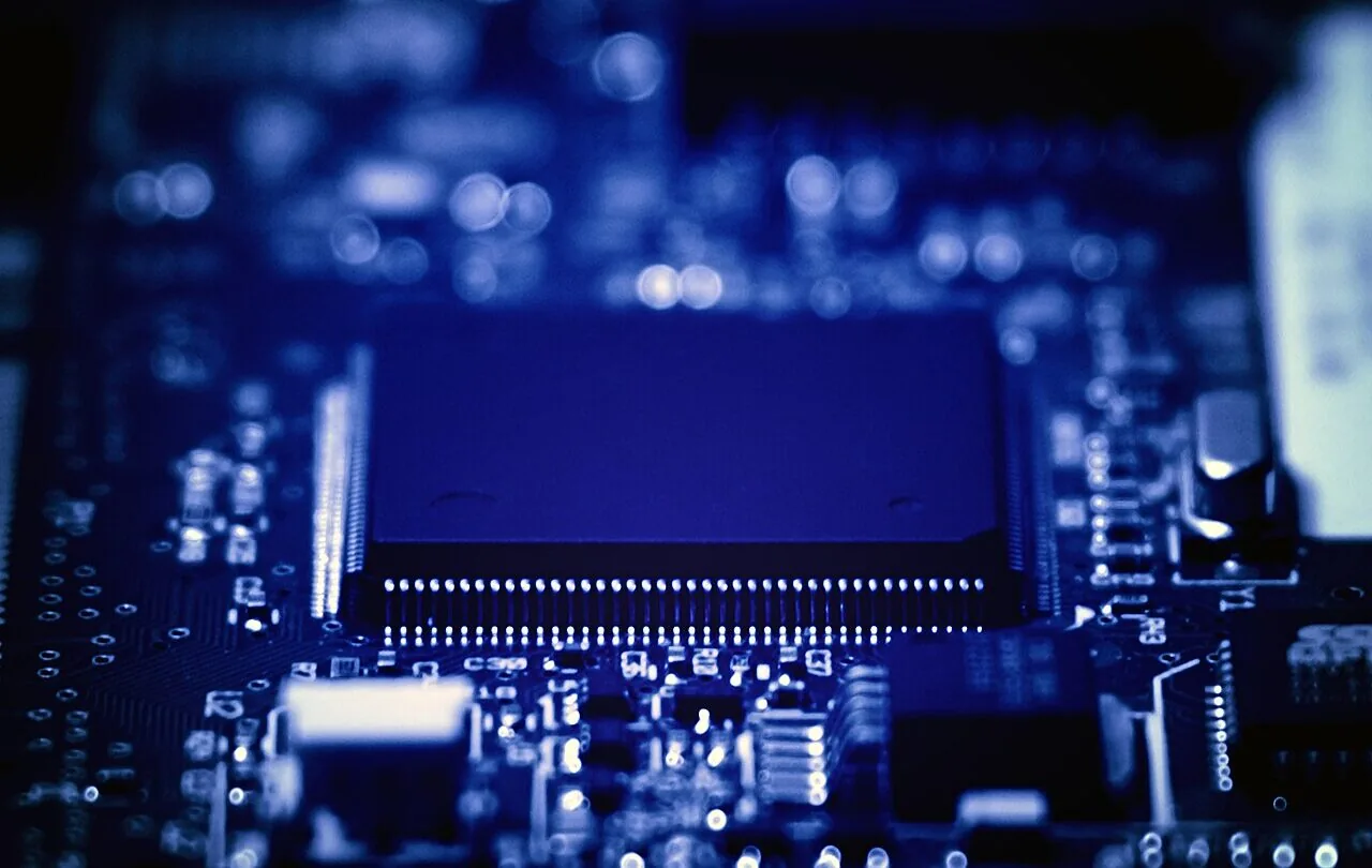 Close-up photograph of a processor and electronic components on a blue circuit board