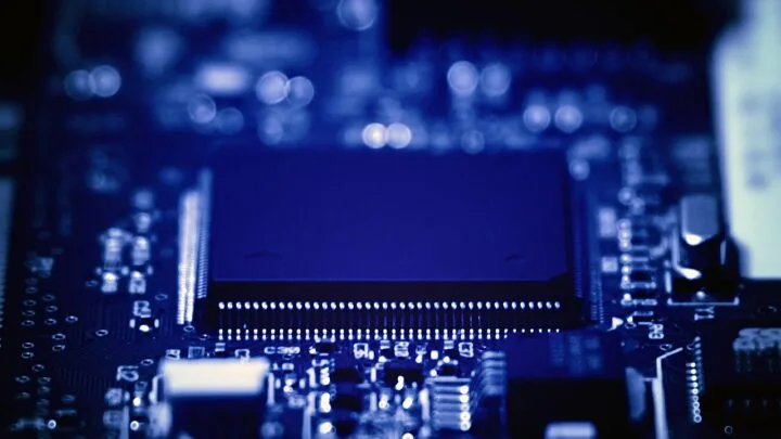 Close-up photograph of a processor and electronic components on a blue circuit board