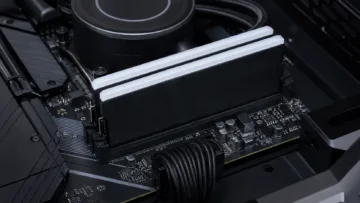 Two desktop RAM modules installed in a gaming PC motherboard