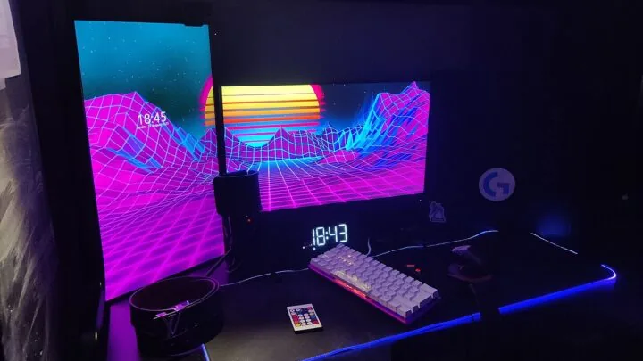 Desktop gaming setup with a widescreen monitor, keyboard and ambient lighting