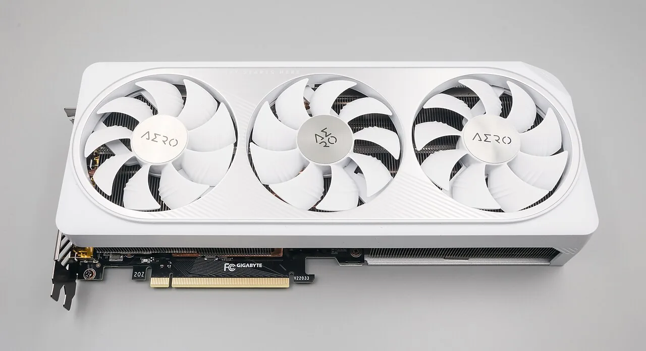 White triple-fan GeForce RTX 4070 graphics card showing its PCI Express connector