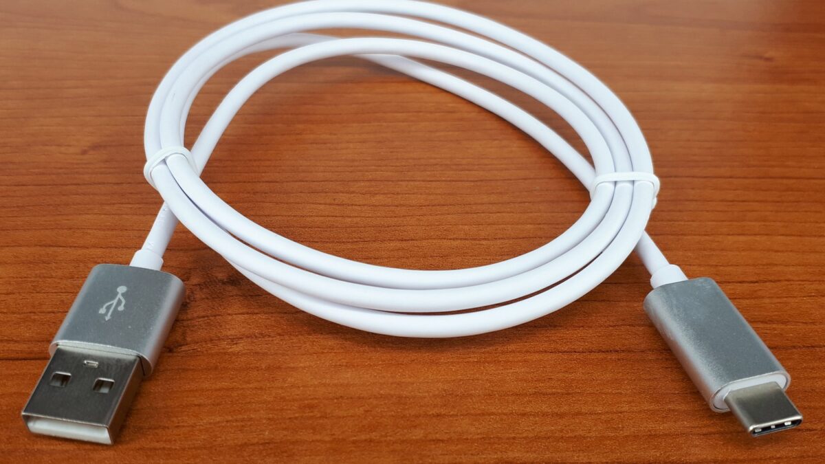 USB Type-C cable photographed on a wooden surface