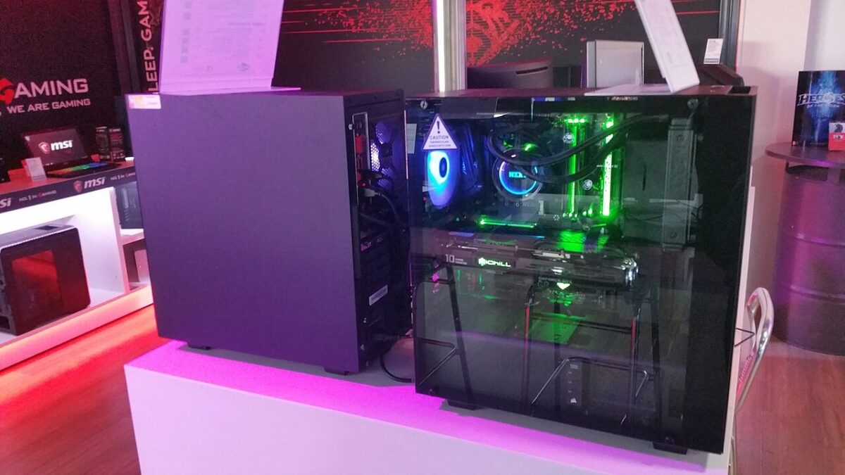 Desktop gaming PC with illuminated internal components in a computer shop